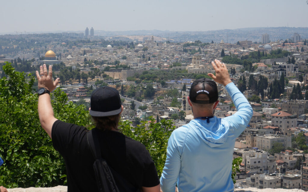 Pastors overlooking Jerusalem with hands raised