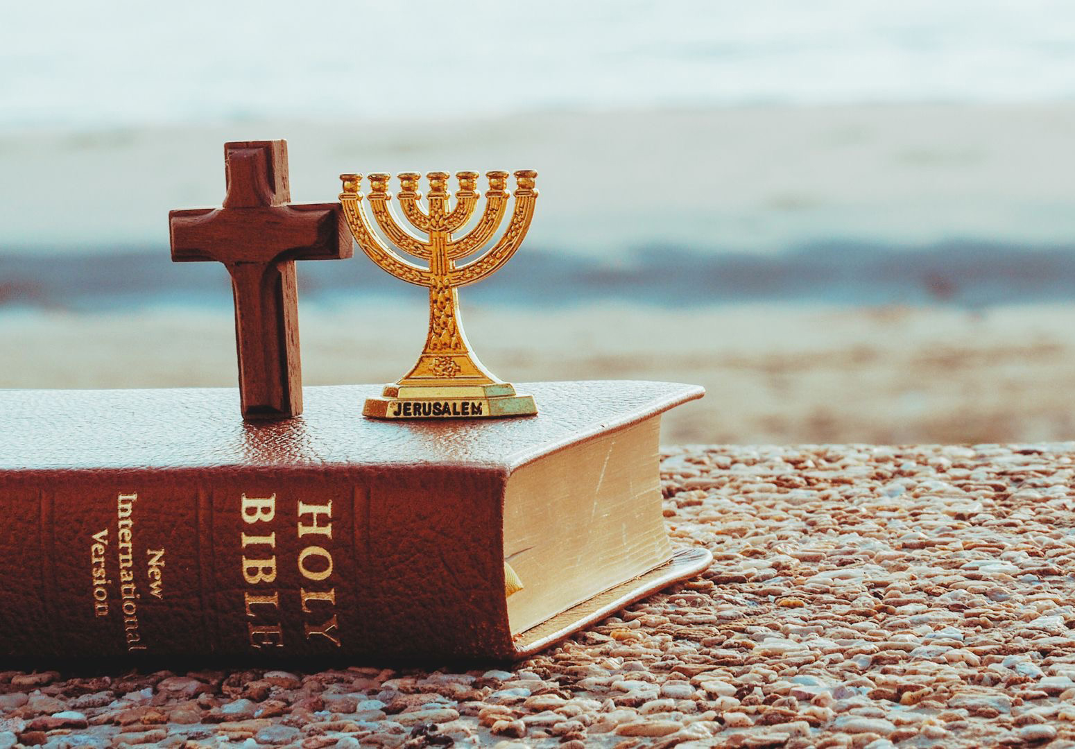 Jewish Menorah and Holy Bible with Cross