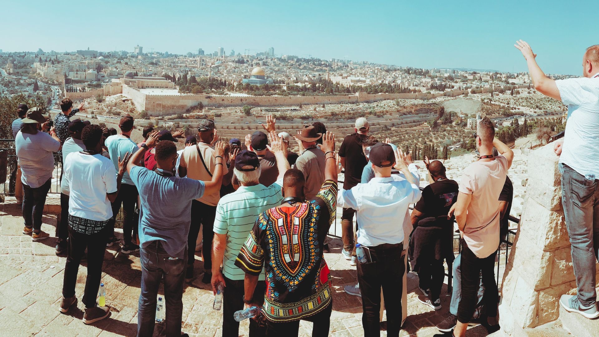 Pastors overlooking Jerusalem with hands raised